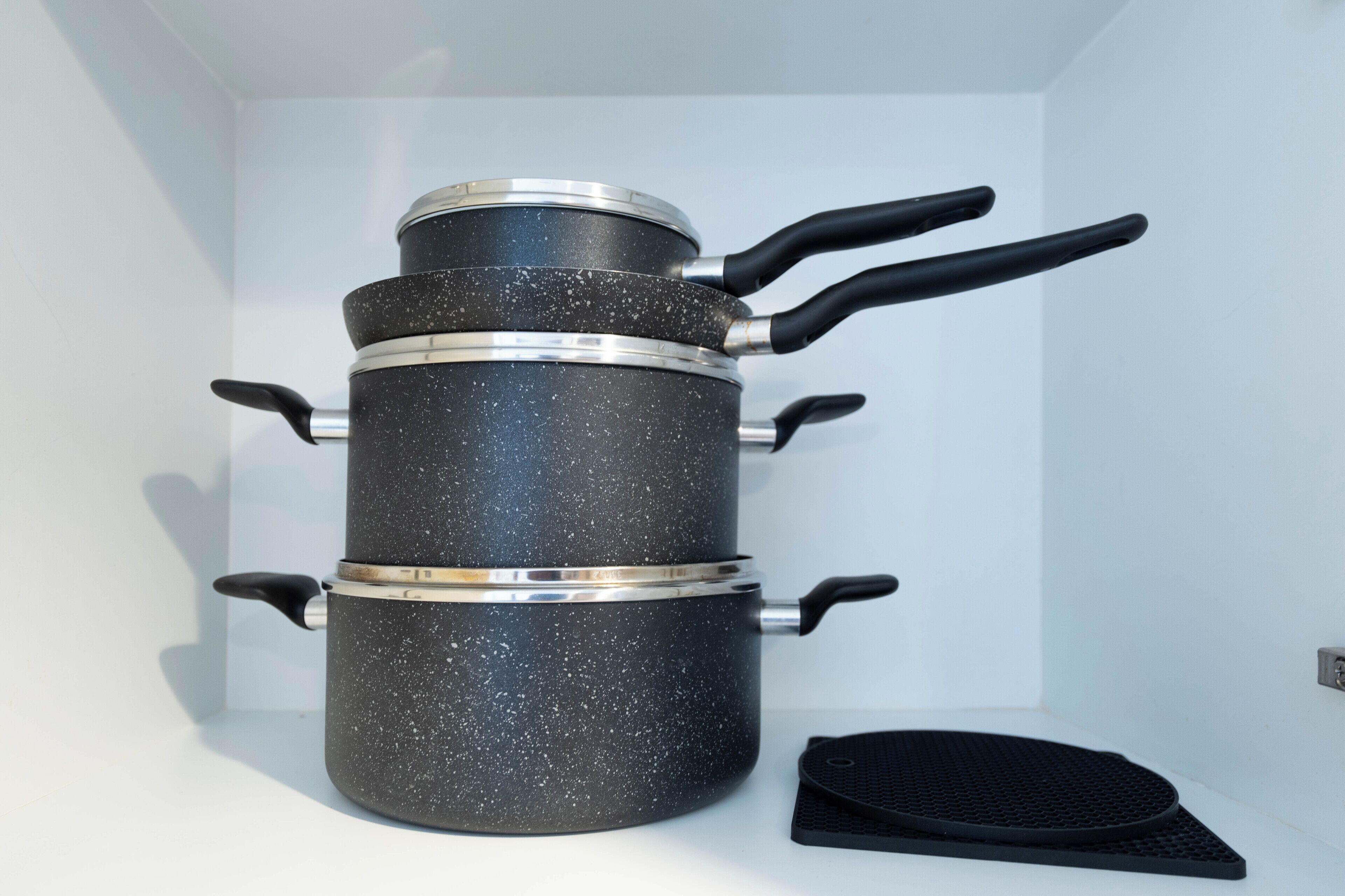 A kitchen with a stove, a sink, and a countertop.