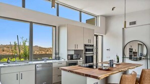 A modern kitchen with a large island, stainless steel appliances, and a view of the desert. - Paradise Canyon-Heated Pool-Mountain View-Estate 2 (Fort Mcdowell)