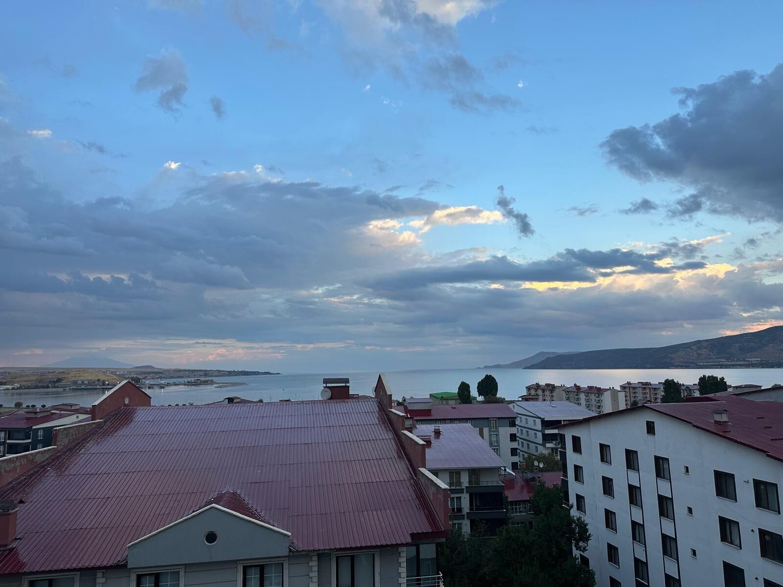 A coastal cityscape with buildings and a body of water.