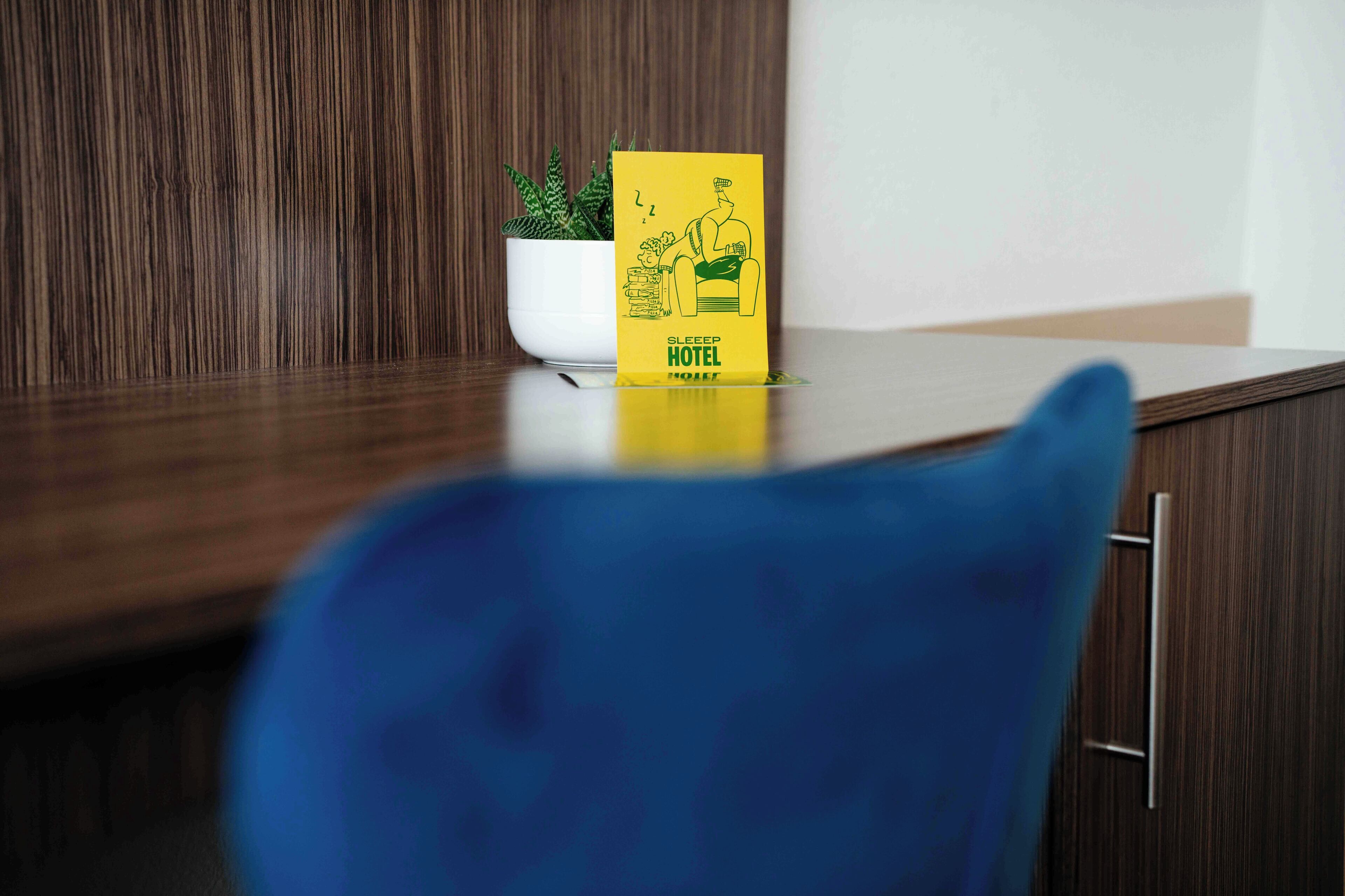 A hotel sign with a sleeping illustration and the text 'SLEEP HOTEL' on a yellow background.