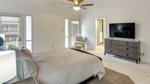 A bedroom with a bed, a TV, a ceiling fan, and a chair. - 5 Mi to Colorado River: Yuma Gem w/ Pool Access! (Yuma)