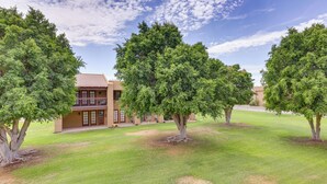 A building with a flat roof and a large tree in front. - 5 Mi to Colorado River: Yuma Gem w/ Pool Access! (Yuma)
