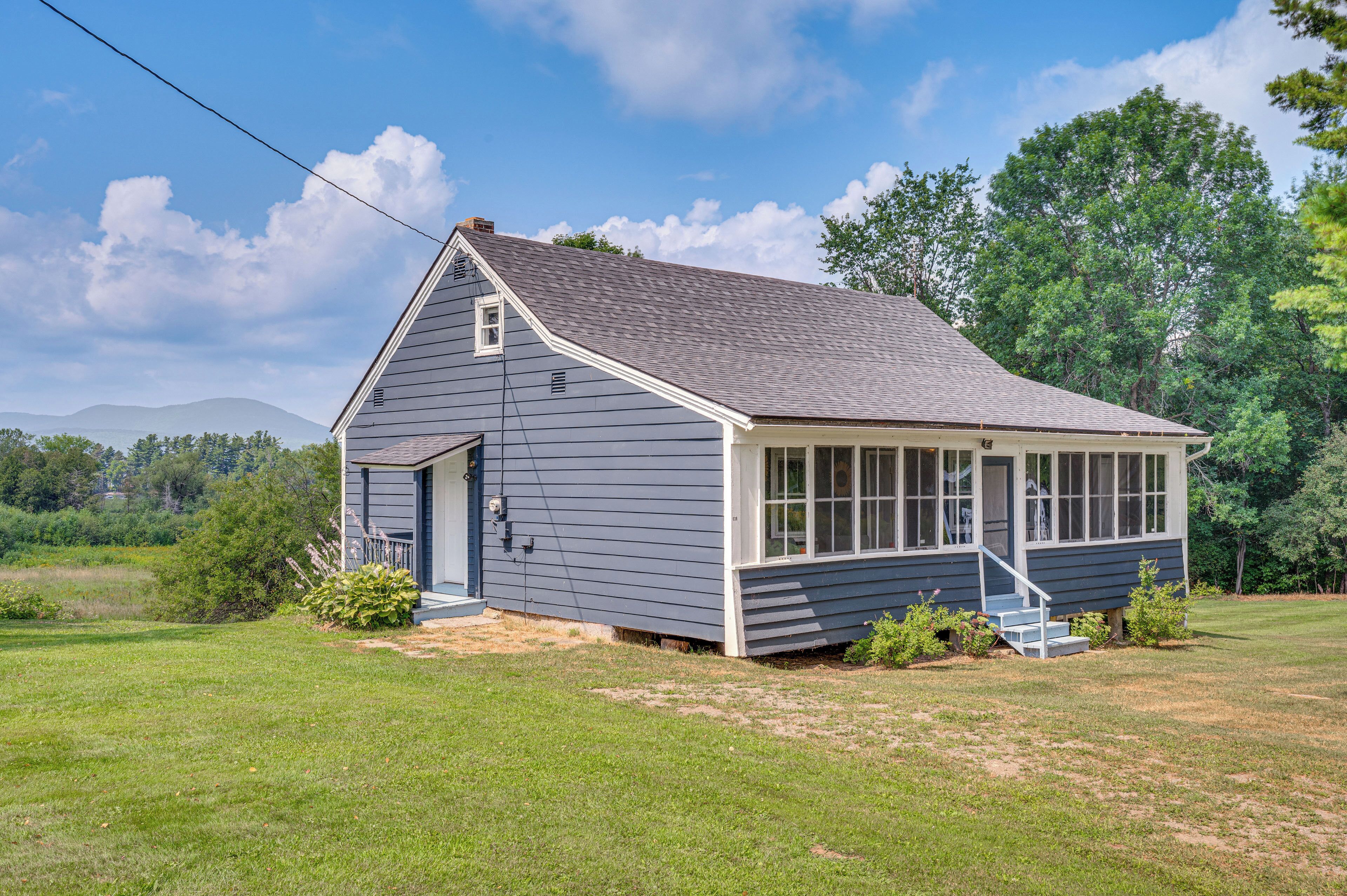 A small, single-story house with a gabled roof and a covered porch.