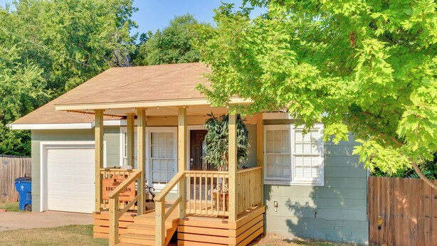 A single-story house with a porch, a garage, and a fenced yard. - Legacy Run: Guthries Historic Haven Near Shops (Guthrie)
