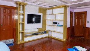 A room with a built-in TV, wooden shelving, and a wooden floor. - 3LDK, 2 private rooms, 1 shared room, spacious kitchen, meeting room, and parking space. (Nagarjun, Kathmandu, Bagmati)