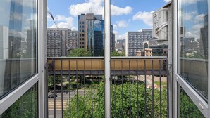 A high-rise building with a view of a cityscape through large windows. - ShortStayPoland Jana Pawla B90 (Warsaw)