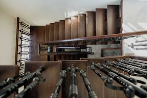A staircase with a wooden finish and a metal railing.