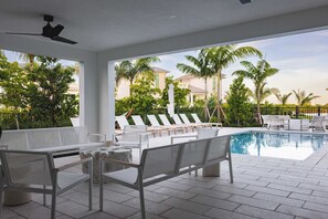 A poolside area with lounge chairs and a pool.
