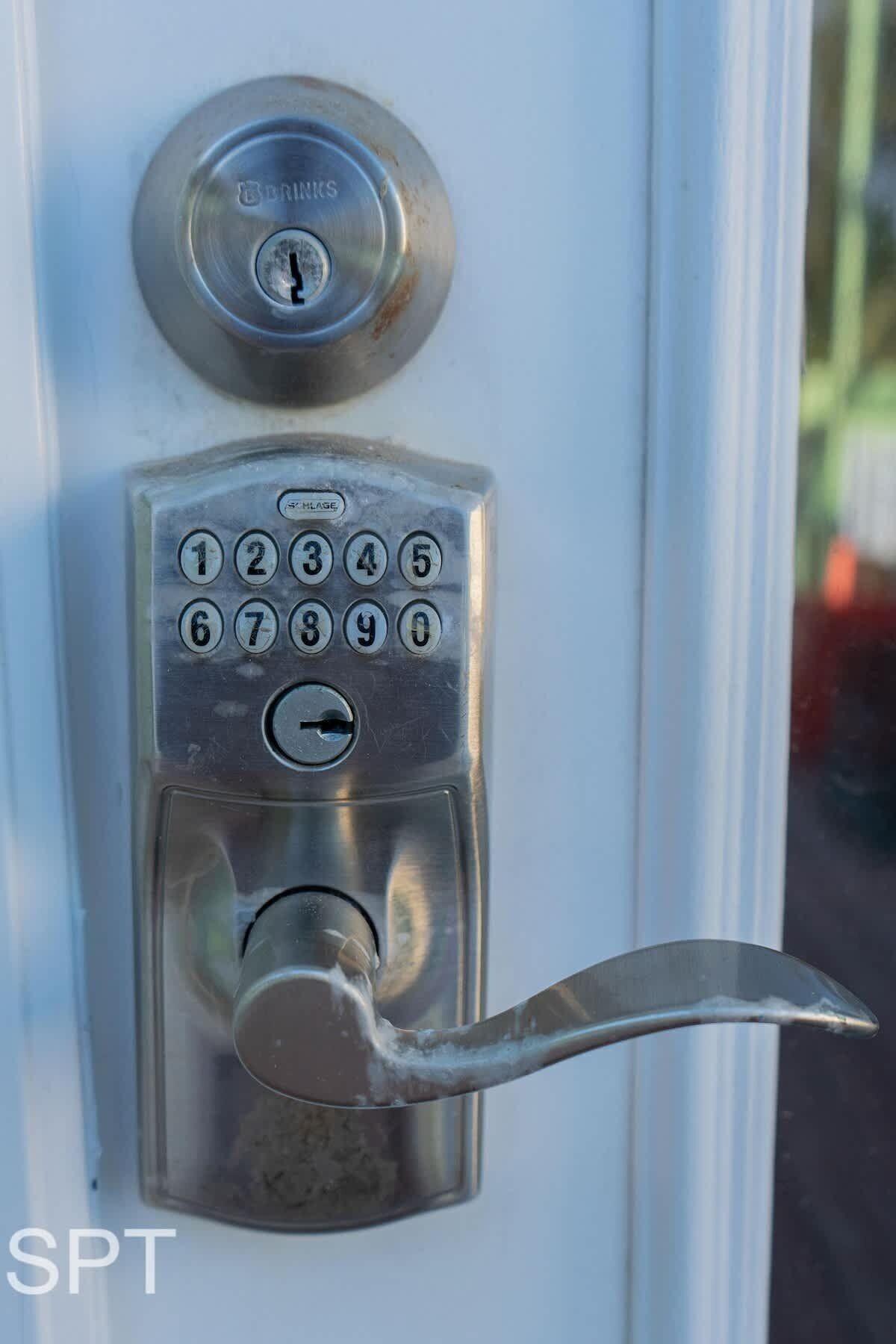 A door lock with a numeric keypad and a keyhole.