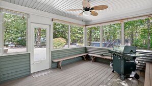 A covered outdoor area with a ceiling fan, wooden benches, and a barbecue grill. - Gray Woodland Escape Golf, Pool & Cinema 5 Bedroom Home (Gray)