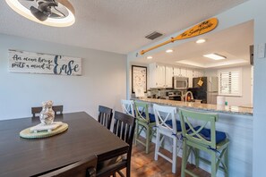 A modern kitchen with white cabinets, a granite countertop, and a built-in oven. - ☀️Easy Beach Access | Great Amenities | Santa Maria 104- The Sunnyside☀️ (Fort Myers Beach)