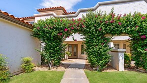 A pathway leading to a house with a tiled roof and a white wall. - Luxury Palm Desert Condo: Pool & Mountain Views (Palm Desert)