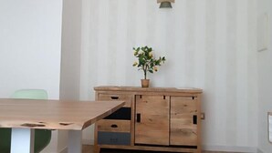 A wooden cabinet with drawers and a potted plant on top.