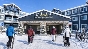 A building labeled 'Mountain Lodge' with a ski lift in the background. - ML178 Great Views & Location EZ Parking  Next To Village (Snowshoe)