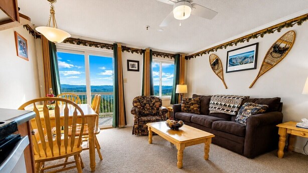 A cozy living room with a sofa, armchair, and dining table. - ML178 Great Views & Location EZ Parking  Next To Village (Snowshoe)