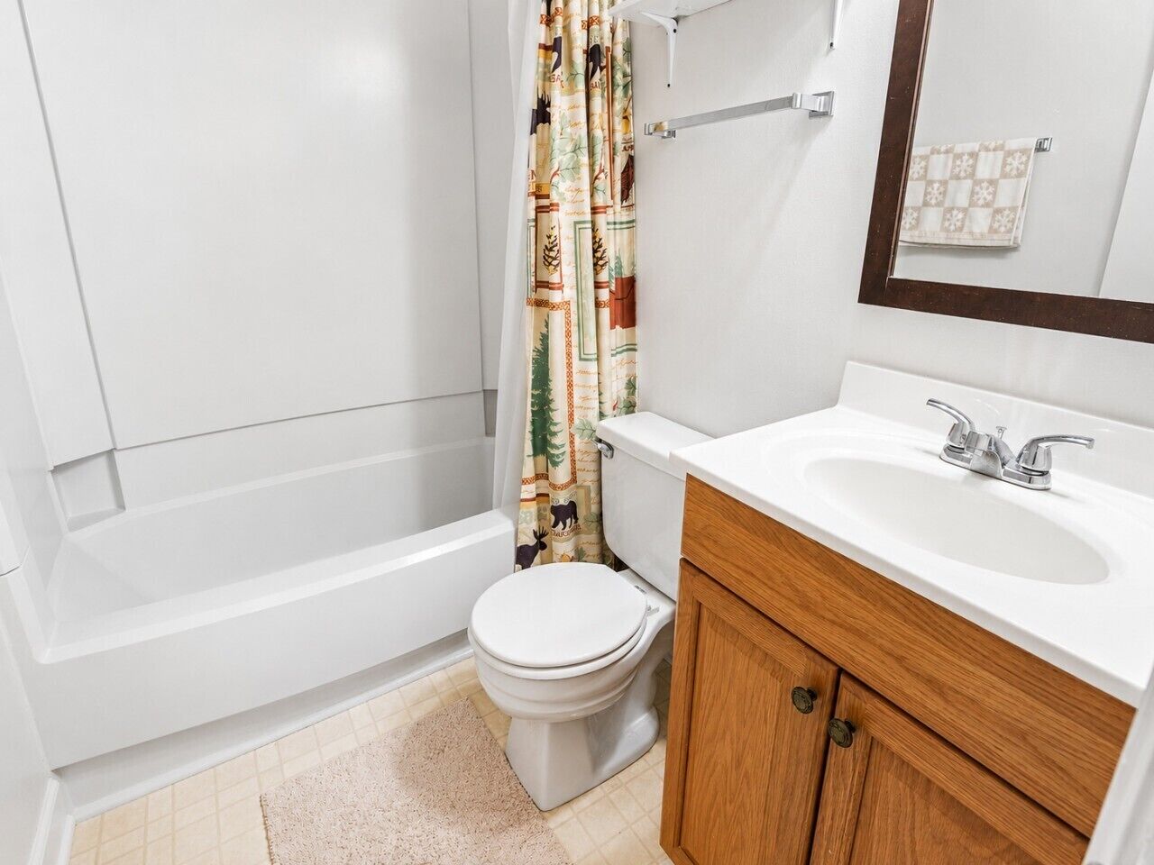 A bathroom with a toilet, a bathtub, and a sink.