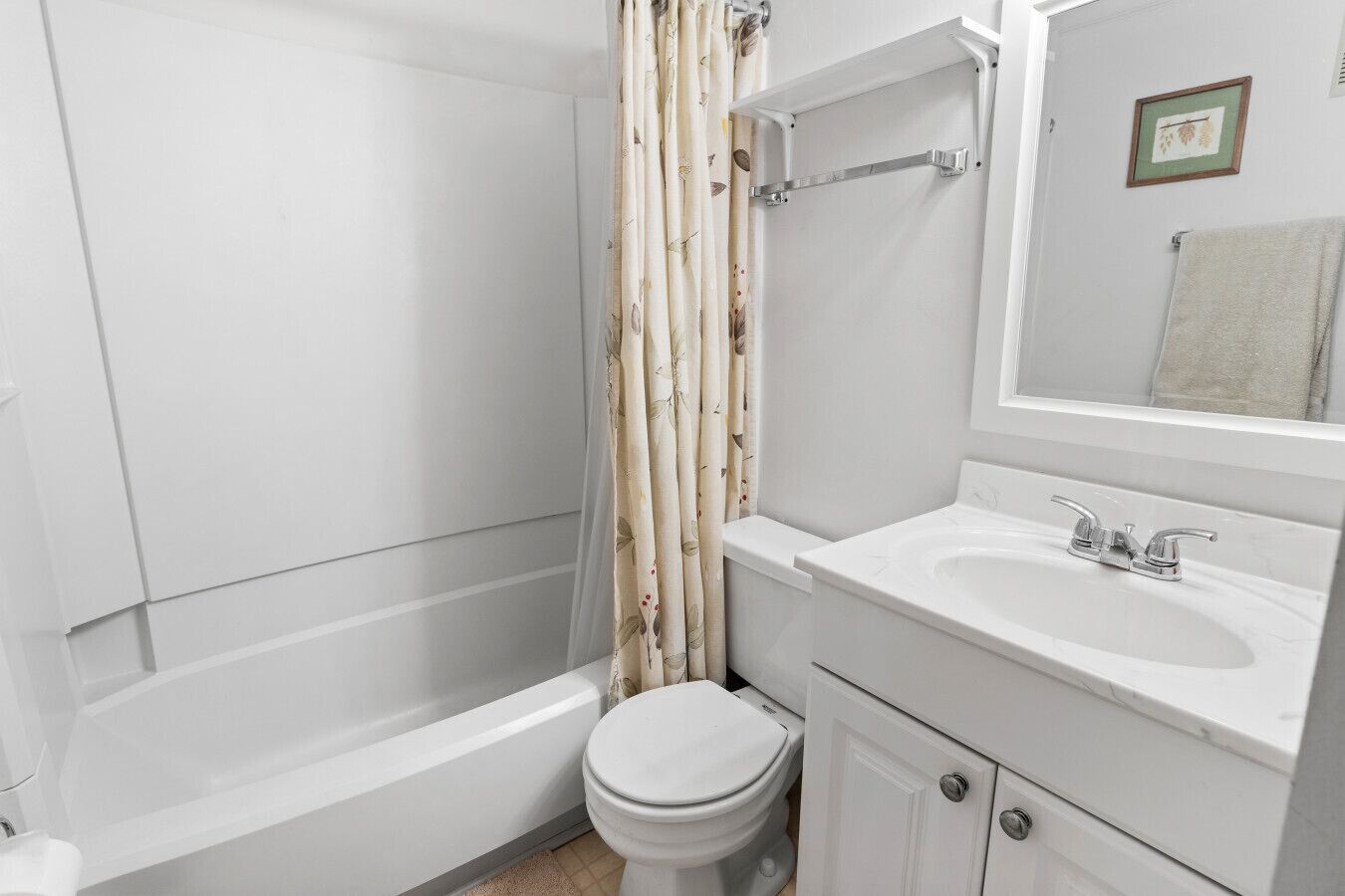 A bathroom with a bathtub, toilet, and sink.