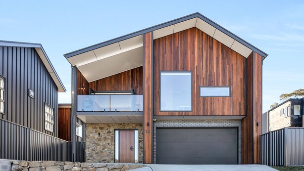 A modern two-story house with a stone facade, a garage, and a balcony. - The Base at Abbott. Unwind with Private Spa -14 Abbott Street (Jindabyne)