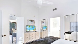 A bedroom with a bed, a dresser, a television, and a mirror. - Nice 3 bedroom condo located in Harbour Oaks (Saint Simons Island)