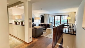 A modern interior with a kitchen, living area, and staircase. - Exclusive deluxe suite in the heart of Kitzbühel (Kitzbühel)