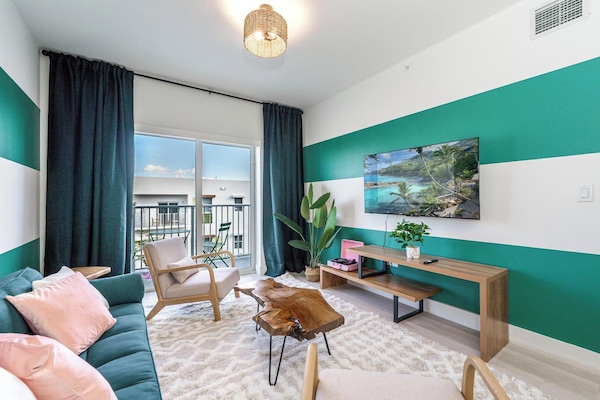 A stylish living room with bold accent walls, sofa bed and blackout curtains