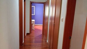 A hallway with wooden flooring and doors on both sides. - Luanda, Angola! Next to the Multipurpose Pavilhao! Centralidade do Kilamba, block M15 (Kilamba)