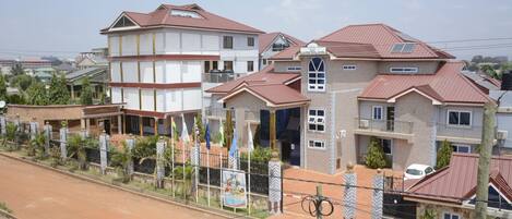 A residential area with houses featuring red-tiled roofs and a mix of architectural styles.