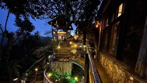 A multi-level outdoor staircase with a wooden deck and railing, leading to a structure with a roof. - OYO 1173 Sermon On The Mount Retreat (Balamban)