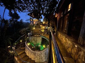 A multi-level outdoor staircase with a wooden deck and railing, leading to a structure with a roof. - OYO 1173 Sermon On The Mount Retreat (Balamban)