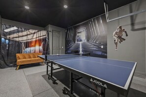 A ping pong table with a wall mural of a space scene and a Star Wars character. - Last Minute Disney! Private Pool, Hot Tub & Themed Bedrooms. Book Now! #118547 (Orlando)
