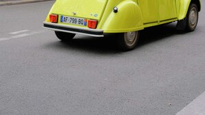 A vintage yellow car parked on a city street. - Spacious Cosy Apartment -2br/8p- Pl. de la Nation (Paris)