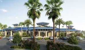 A hotel with a modern architectural design, featuring a central entrance flanked by palm trees, a parking lot, and a clear sky. - Last Minute Disney Getaway! Private Pool & Themed Bedrooms. Book Now! #118521 (Orlando)