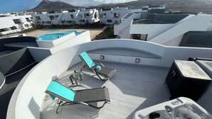 A rooftop terrace with lounge chairs, a hot tub, and a swimming pool. - MarVillaFuerte - One Bedroom Apartment, Sleeps 4 (La Oliva)