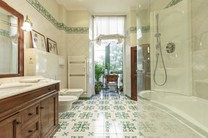 Een douche, een bidet, handdoeken, shampoo