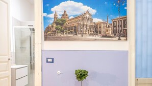 A bathroom with a shower, a sink, and a mirror. - GuestHost - Central apartment Caronda street (Catania)