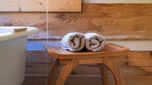 A wooden stool with rolled towels in a room with wooden walls and a window. - DreamForest 3BR, Firepit, Foosball, Banner Elk (Banner Elk)