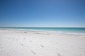 A beach with white sand and clear blue water. - Tivoli by the Sea 5286 (Miramar Beach)