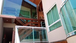 A multi-level building with glass railings and wooden accents.