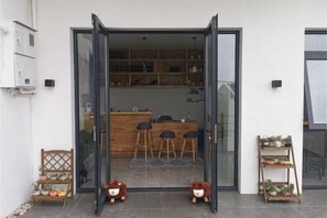 A modern interior with a bar area, seating, and a display shelf.