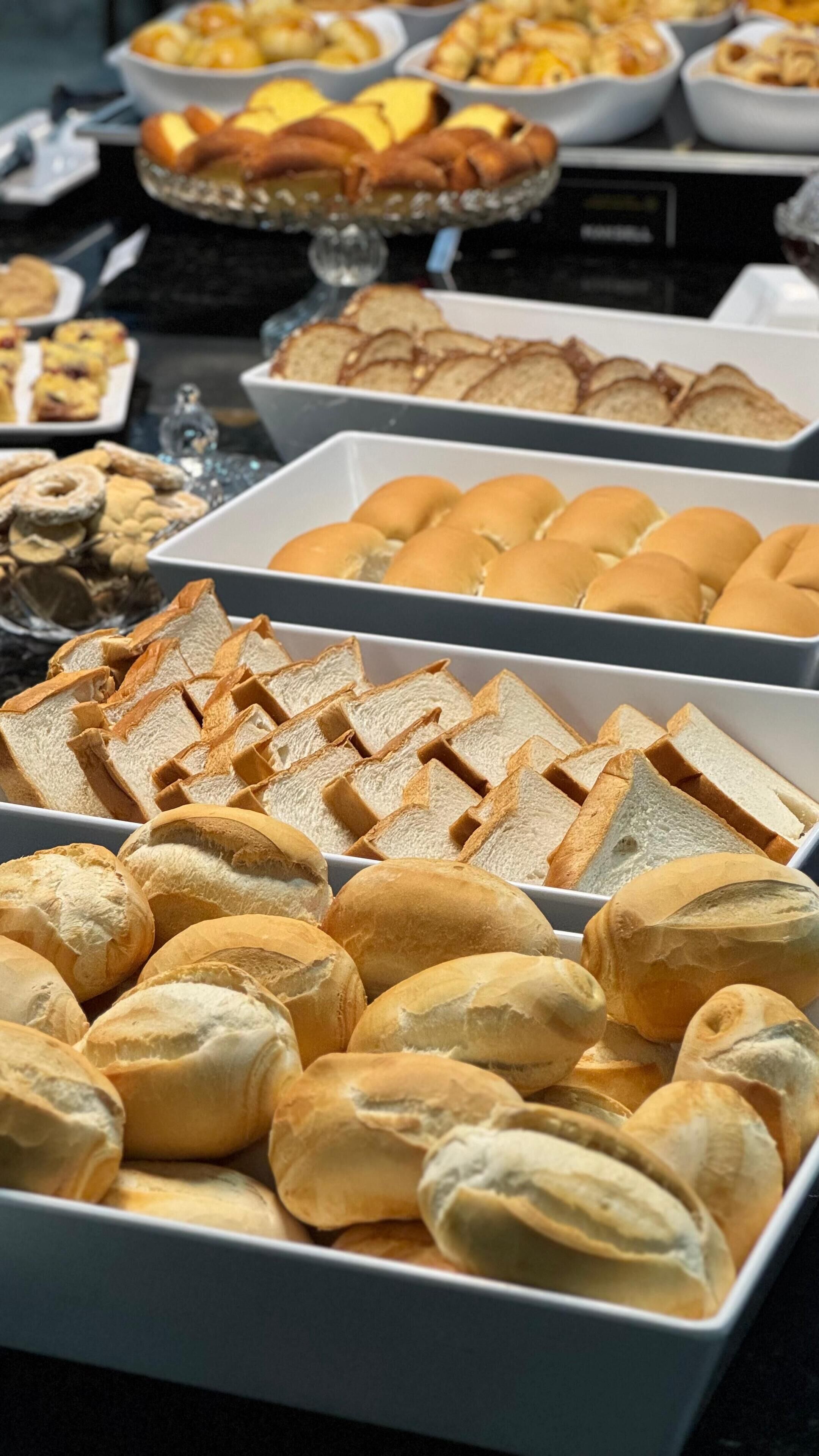 A buffet with various bread and pastries.