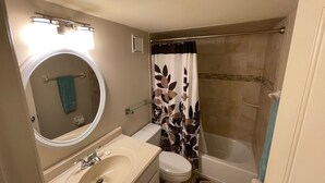 A bathroom with a sink, toilet, and bathtub. - Ground Floor Ocean View 2/2 (New Smyrna Beach)