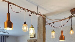 A modern kitchen with a large island, stainless steel sink, and hanging pendant lights. - A balcony overlooking the magnificent ochre cliffs of Roussillon (Roussillon)