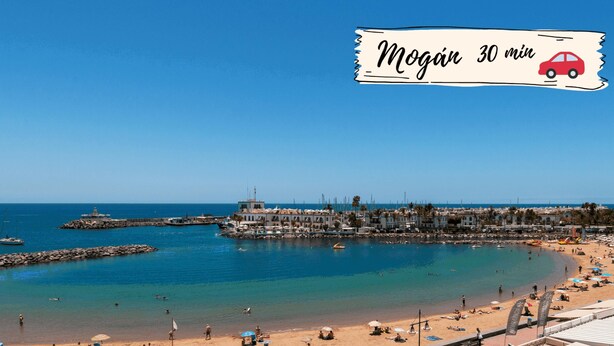 A coastal town with a beach, boats, and buildings along the waterfront. - Careva Suites 21 by VillaGranCanaria (San Bartolomé de Tirajana)