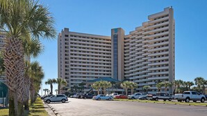 A multi-story hotel with a modern architectural design, featuring a prominent vertical tower and a series of balconies. - Sundestin 1103 (Destin)