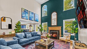 Una sala de estar con chimenea, un conjunto de sofás y una mesa de centro.