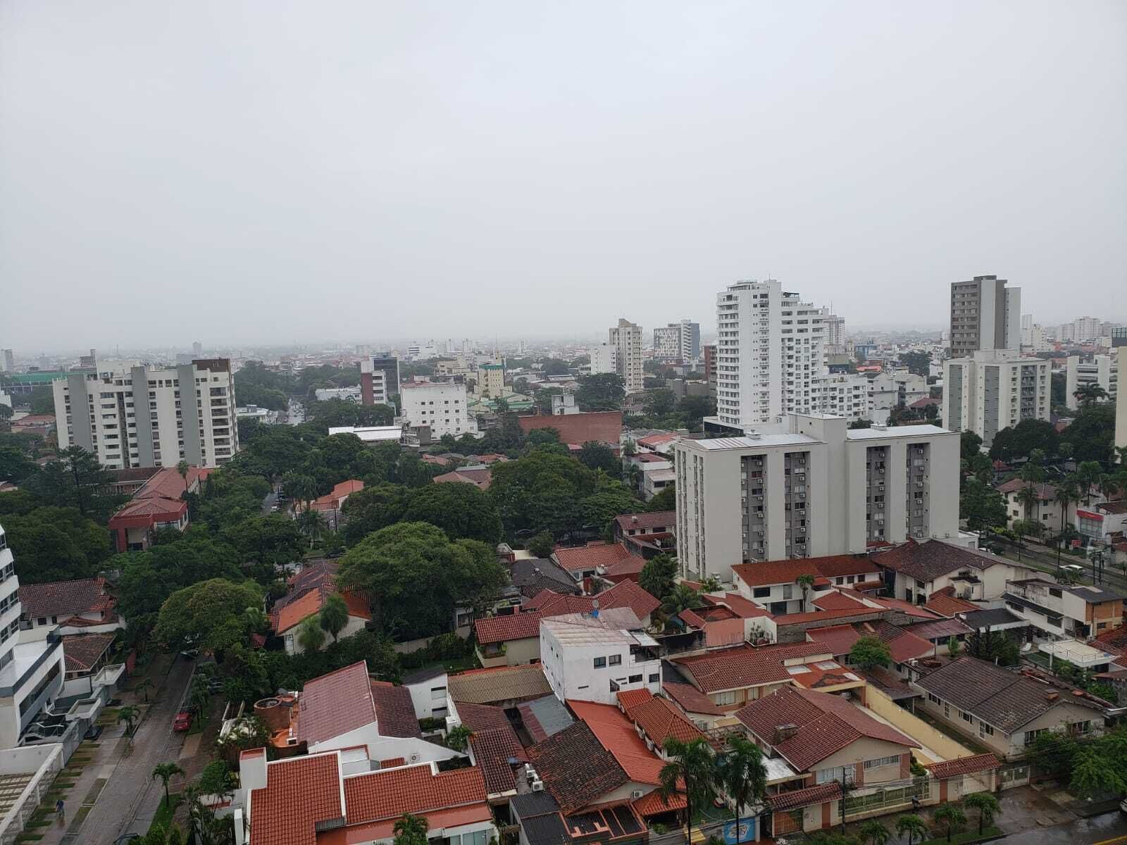 A cityscape with high-rise buildings, residential areas, and greenery.