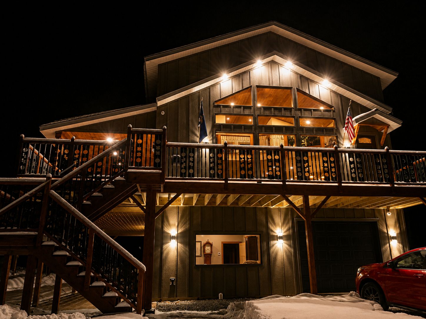 A two-story building with a balcony, a staircase, and a garage.