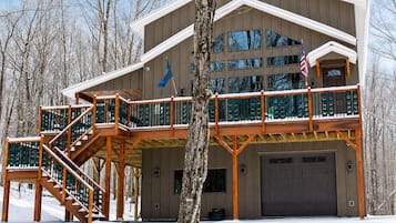 A two-story building with a covered deck and a garage.