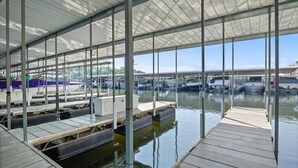 A covered marina with docked boats and a clear view of the water. - Lake View Condo - Heart of Osage Beach + Boat Slip (Osage Beach)
