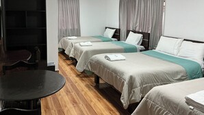 A hotel room with two single beds, a small table, and a chair. - CUSCO VISTA GUETS HOUSE (Cusco)